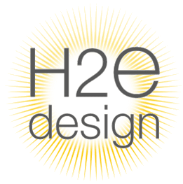 Logo for H2E design with a radiant yellow sunburst background.
