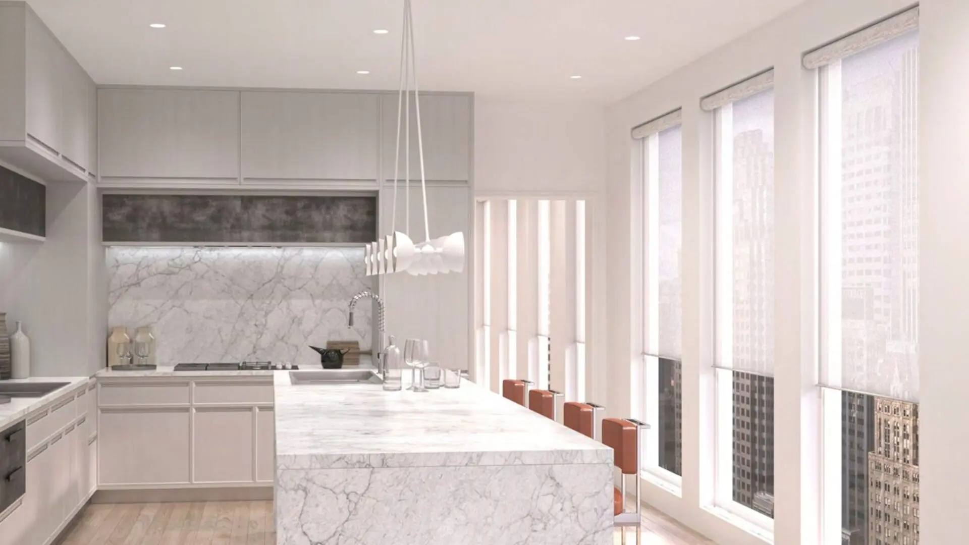 Modern kitchen with marble island and pendant lighting.